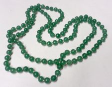 A Jade Bead Necklace, 116cm long, approximately 8mm diameter beads