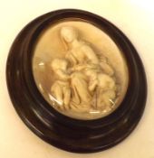 A 19th Century Italian Oval Composition Plaque, decorated with mother and children, bears