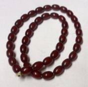 A Cherry Amber type oval Bead Necklace, 56cm long