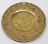 A Chinese Brass Circular Plate, the top incised with dragons and smoke clouds and the base with 6