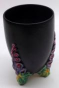 A Clarice Cliff Vase of tapering circular form, “My Garden”, the plain black body with floral relief