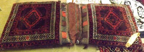 An Afghan Large Saddle Bag, comprising two large cushions joined by central panel, the cushions