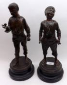 A pair of Bronzed Spelter Figures of young boys, after Rancoulet, raised on turned ebonised bases,