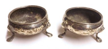 A pair of George III Round Salts, raised on swept legs with hoof feet, marks heavily rubbed,