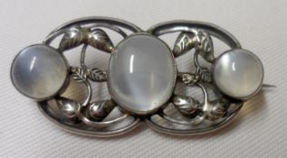 An Art Nouveau white metal framed and three Moonstone Brooch (handmade glass panelled box)