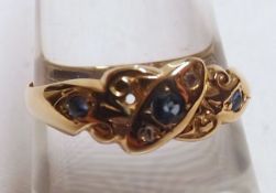 An Edwardian hallmarked 18ct Gold Ring set with three small Pale Blue Sapphires and two (of four)