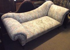 A Victorian Chaise Longue with sloped back, upholstered in an abstract patterned fabric, (some