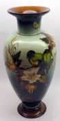 A large Doulton Lambeth Faience Baluster Vase, decorated with a scene of birds amongst foliage, on a