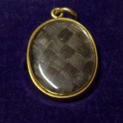 An early Victorian mid-grade Gold Oval Locket Pendant with plaited hair reverse panel, 27mm x 20mm