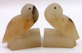 A pair of early 20th Century Polished Marble Bookends, modelled as parrots, 6 ½” high (one A/F)