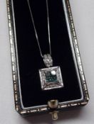 A hallmarked 9ct White Gold Square Pendant, featuring four Blue Tanzanites to the centre