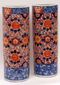 A pair of Japanese Imari Cylindrical Stick Stands, each typically painted in traditional colours, 24