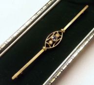 An Edwardian 15ct Gold Bar Brooch, the oval openwork centre set with a centre small Pale Blue