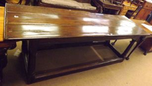 An 18th Century Oak Refectory Table, three plank top, raised on four turned legs to a stretcher