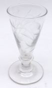 A decorative small conical Wine Glass etched with a flowing foliate motif on a single knopped stem