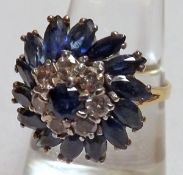 A hallmarked 18ct Gold Dress Ring, featuring fourteen Marquise Cut Mid-Blue Sapphires, centre