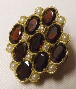 A 20th Century hallmarked 9ct Gold oval Lapel Brooch, set with a Diamond shaped pattern of Garnets