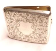 A George V Cigarette Case of slightly curved form, decorated with chased floral decoration,
