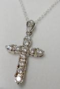 A white metal and all White Sapphire set Cross, 33mm drop, stamped “.925” and mounted on a trace