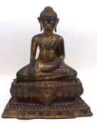 A Gilded and Bronzed Cast Metal Figure of a seated deity in the lotus position, standing on integral
