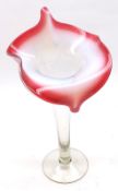 A Red Vaseline and Clear Glass Jack in the Pulpit Vase, on tapering stem and round foot, 11” high