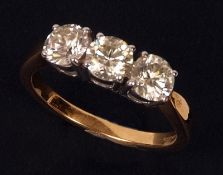 A fine 18ct Gold three stone Brilliant Cut Diamond Ring of approximately 1.5 ct total