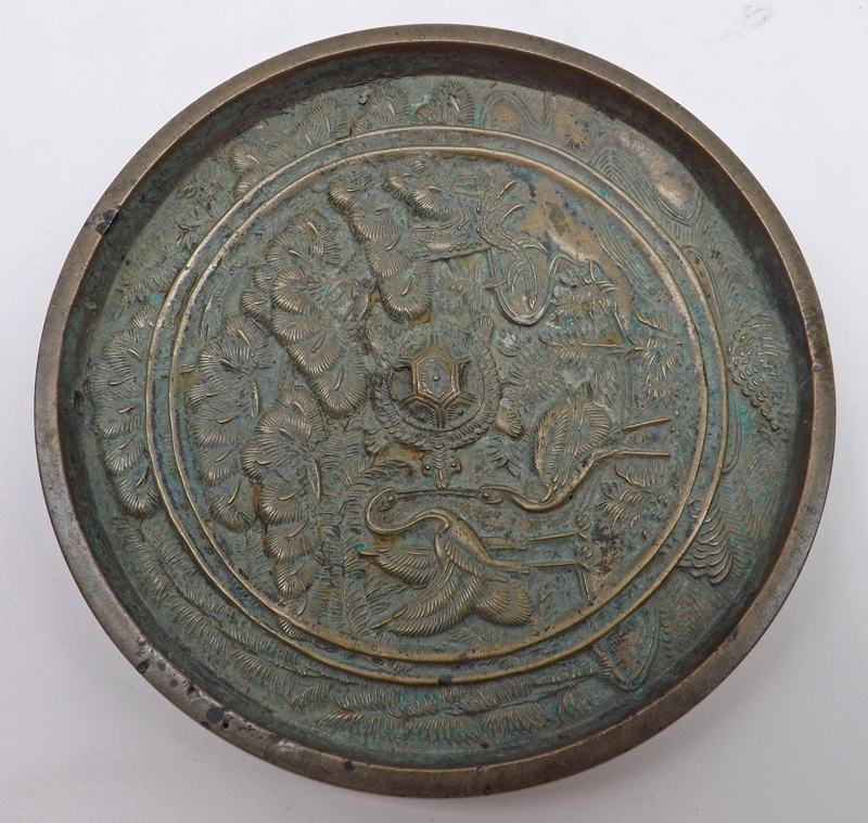 An Oriental Bronze Circular Medallion, embossed with cranes, foliage and central turtle, 4 ½”