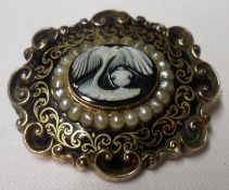 An early Victorian Black Enamel and Pearl Mourning Brooch with Hardstone Cameo centre, depicting