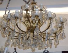 A 20th Century twelve branch gilt metal and clear glass Chandelier with extensive hanging