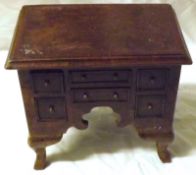 A Walnut Apprentice’s Lowboy, with moulded edge and banded top, fitted below with two central