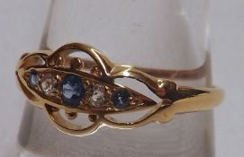 An early 20th Century hallmarked 18ct Gold Ring, the shaped pierced front panel set with three