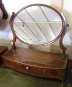 An early 19th Century Mahogany Bow Front Dressing Table Mirror with three drawers, raised on small