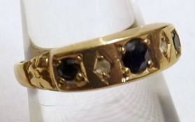 A hallmarked 9ct Gold three small Dark Blue Sapphire and two small Brilliant Cut Diamond Ring