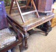 A Victorian Gothic Oak Extending Dining Table, the corners with carved lion mask detail, raised on