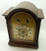 An early 20th Century Mantel Clock, the arched case over freestanding barley twist columns to a