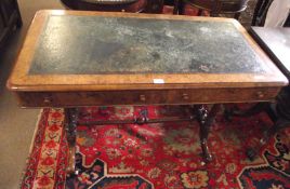 A Victorian Walnut Desk with faded green leather inset over two frieze drawers and raised on four