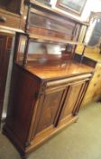 A William IV or early Victorian Mahogany Chiffonier, the panelled back with two shelves on turned