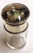 A small Dressing Table Bottle, the lid decorated with a scene of Dutch couple to a clear glass