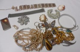 A bag of assorted mainly Costume Jewellery including Bangles, Brooches, Cameos etc