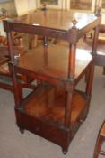 A Victorian Mahogany Three Tier Whatnot, of square form, the upper tier crested with four urn