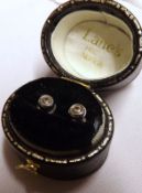 A pair of unmarked precious metal small Solitaire Diamond Stud Earrings