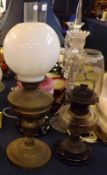 A late Victorian Oil Lamp with clear glass chimney, opaque glass shade, brass font and a spreading