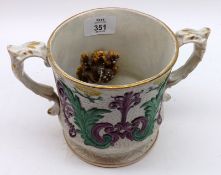 A 19th Century Staffordshire double-handled Frog Mug, the exterior decorated with coloured foliage