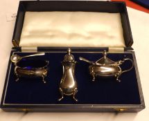 A Queen Elizabeth II Cased Three Piece Condiment Set, comprising Salt and Mustard with blue glass