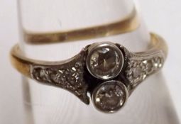 An early 20th Century 18ct Gold and Platinum Ring set with two small Brilliant Cut Diamonds and