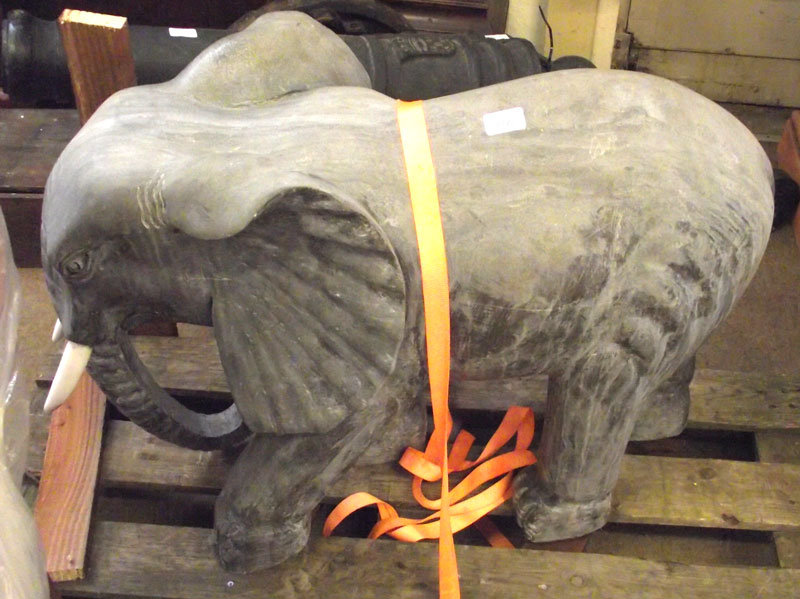 A 20th Century Cast Metal Model of a baby elephant, 30” long