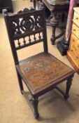 A Victorian Oak Hall Chair, the pierced back and seat carved with Gothic style flower detail, raised