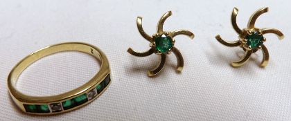 A high grade precious metal Half Hoop Ring set with six small Emeralds and two small Brilliant Cut