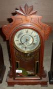 A late 19th Century Gingerbread type Mahogany Cased Mantel Clock, glazed door enclosing a brass