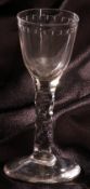 An 18th Century Wine Glass, the bowl with egg and dart etched rim on a facetted stem, terminating in